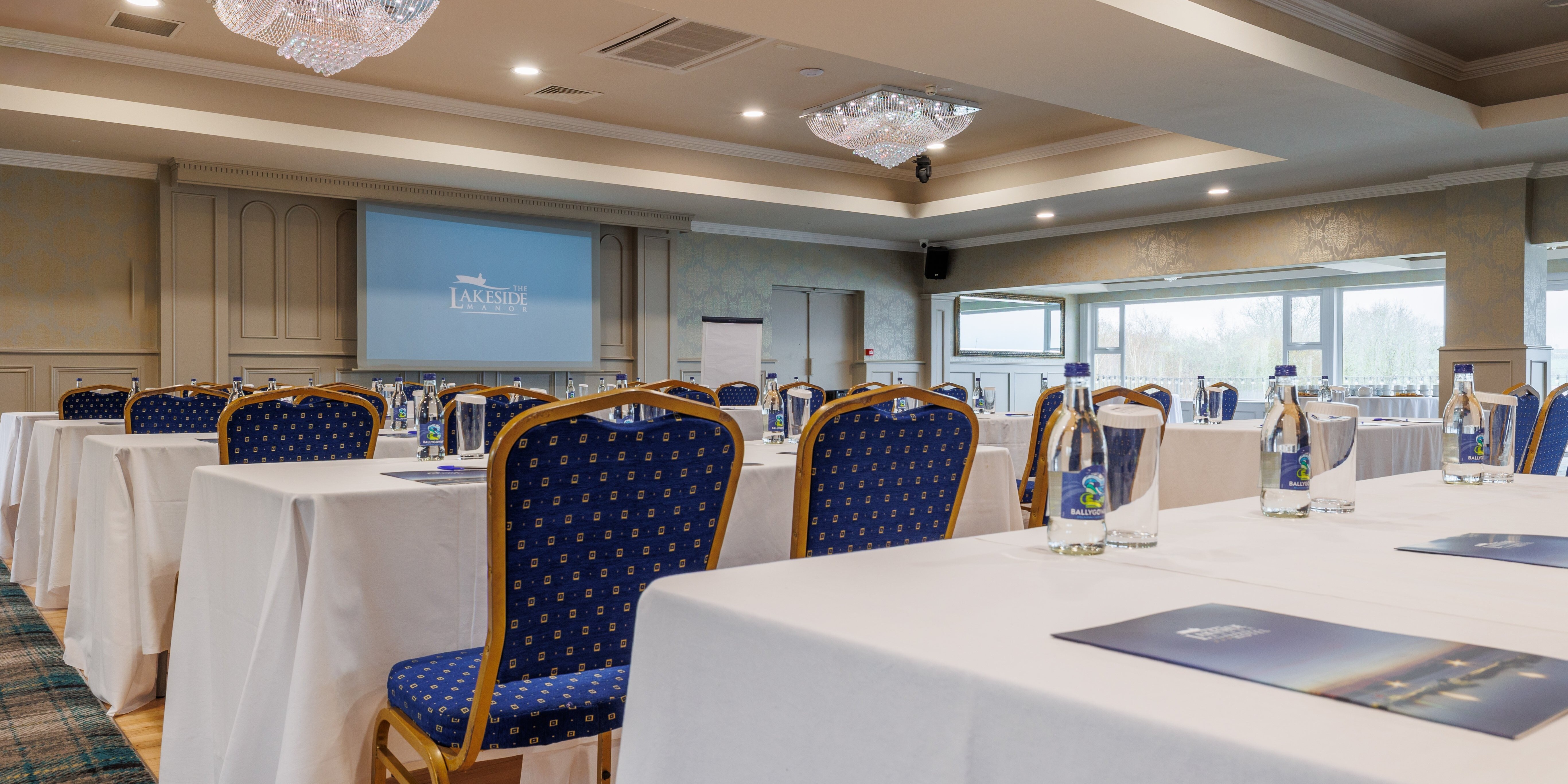 Conference room set up in classroom style at The Lakeside Manor overlooking Lough Ramor, with projector screen, tables, chairs and meeting facilities for corporate events in County Cavan.